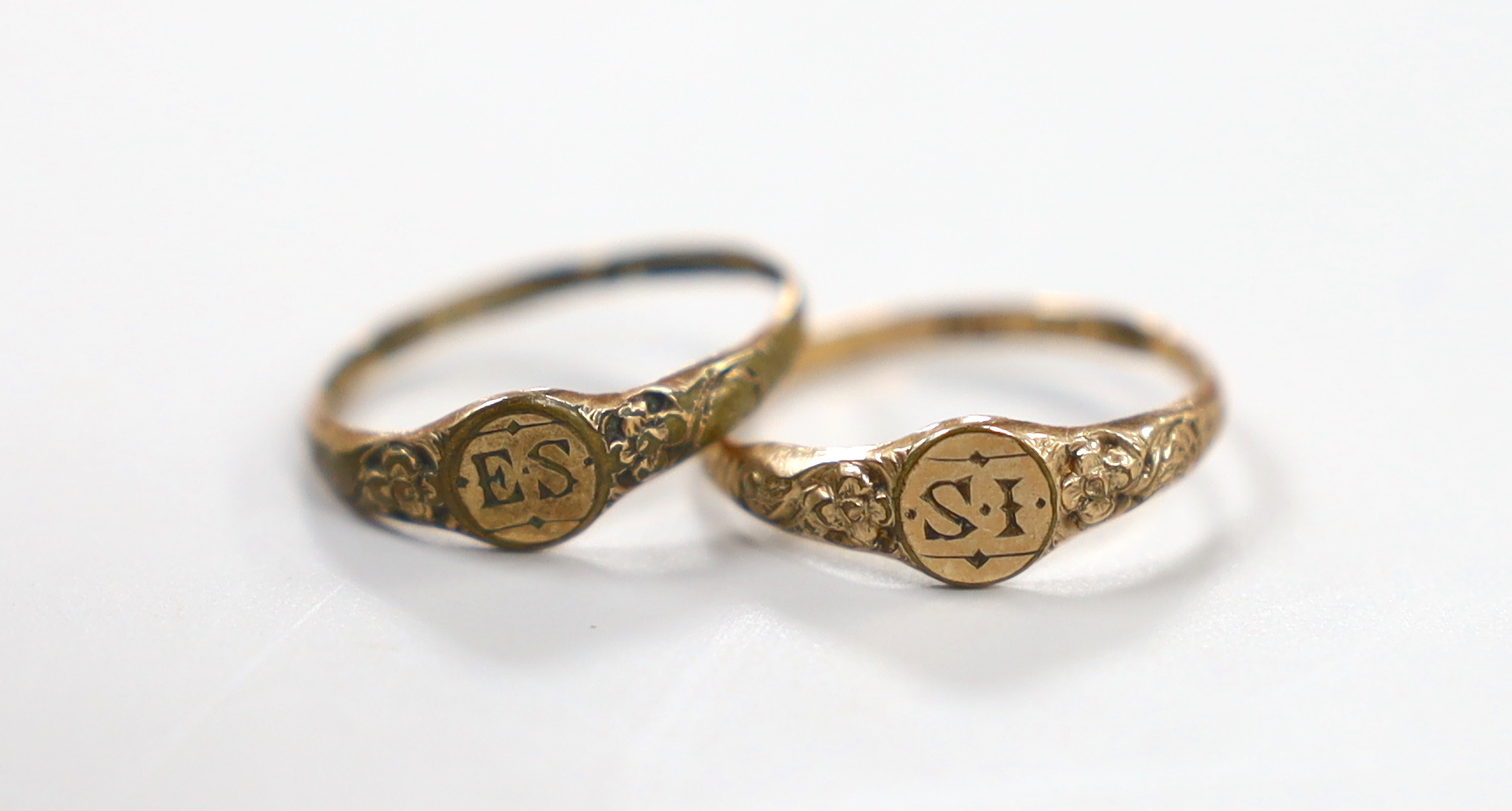 A pair of Georgian 'gold shell' child's rings, the rings heads with engraved initials, 'IS' and 'AS', sizes D/E and G.
